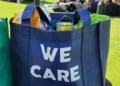 A shopping bag in blue with the words 'we care' - altruism