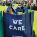 A shopping bag in blue with the words 'we care' - altruism