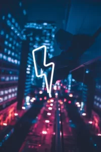A neon lightning bolt against a blue and purple city backdrop