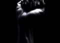 A raised fist against a black background