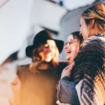 three women laughing and talking outside social constructionism