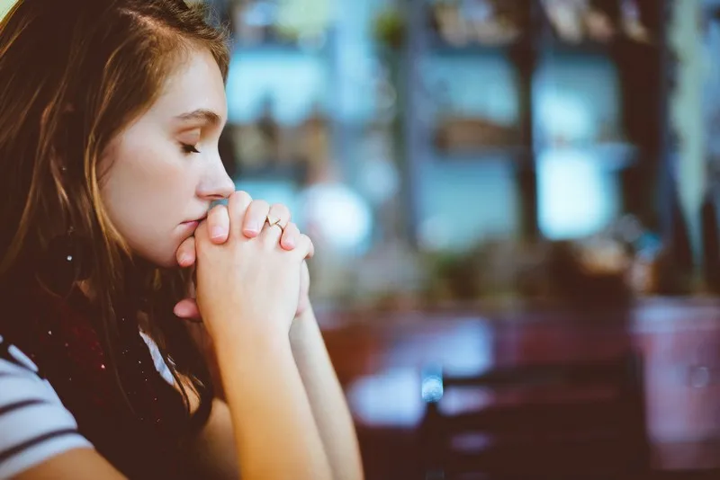 A young lady praying