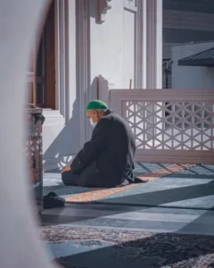 a muslim man praying on his knees - religion