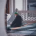 a muslim man praying on his knees - religion