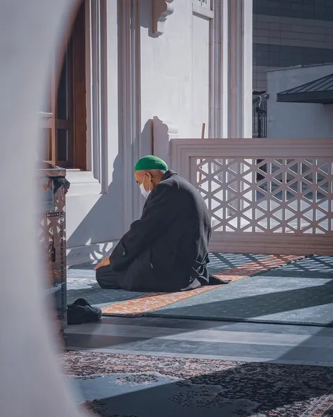 a muslim man praying on his knees - religion