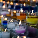 Line of multi-coloured candles in glasses