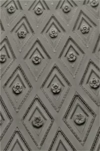 A wall decorated with diamond shapes containing flowers - reproduced, habitus, habitual