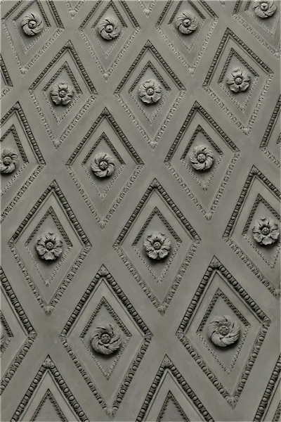 A wall decorated with diamond shapes containing flowers - reproduced, habitus, habitual