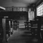 A dilapidated school in black and white