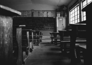 A dilapidated school in black and white