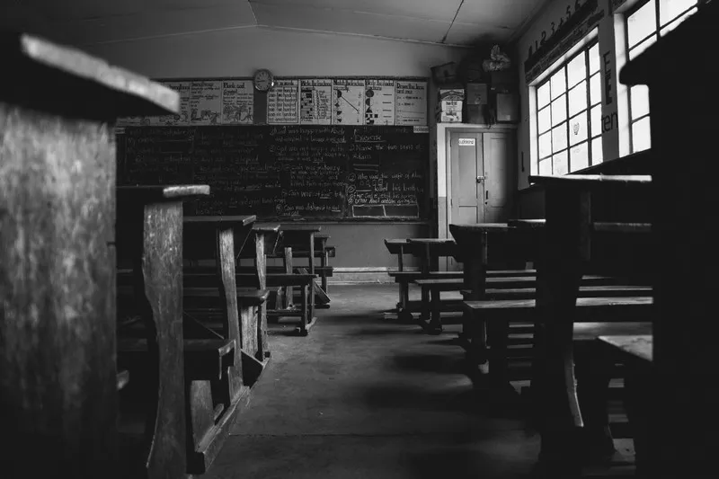 A dilapidated school in black and white