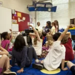 a group of young children sat on the classroom floor