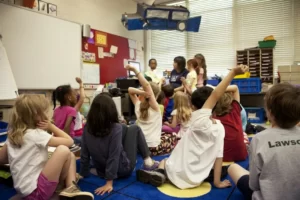 a group of young children sat on the classroom floor