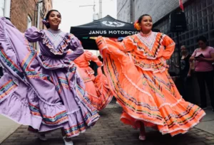 two women dancing in colourful cultural dress