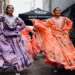 two women dancing in colourful cultural dress