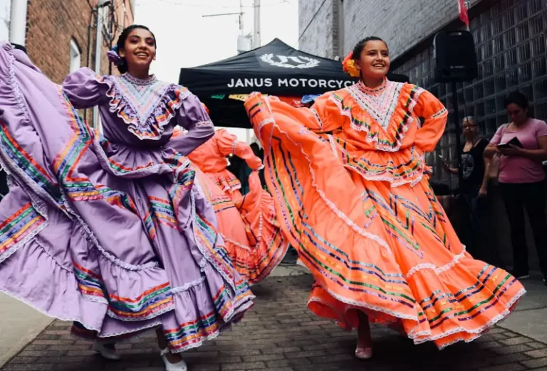 two women dancing in colourful cultural dress