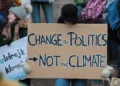 Protest placard reading 'change politics not the climate'