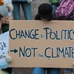 Protest placard reading 'change politics not the climate'