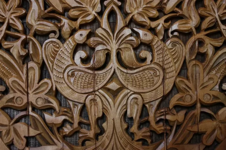 A wood carving of two birds animism