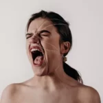 a woman screaming or shouting to represent symbolic violence and language
