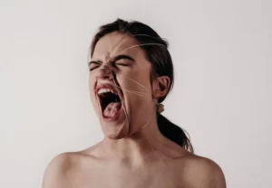 a woman screaming or shouting to represent symbolic violence and language
