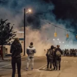 a violent street protest with smoke