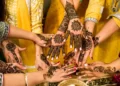 A group of womens hands adorned with cultural henna tattoos