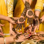 A group of womens hands adorned with cultural henna tattoos