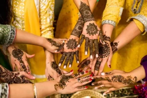 A group of womens hands adorned with cultural henna tattoos