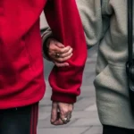 A person linking arms with another