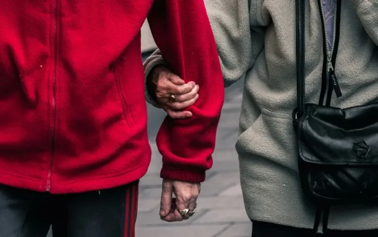 A person linking arms with another