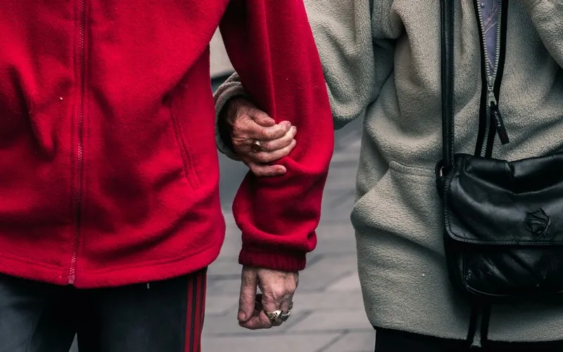 A person linking arms with another