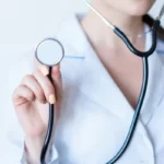 A female doctor holding a stethoscope