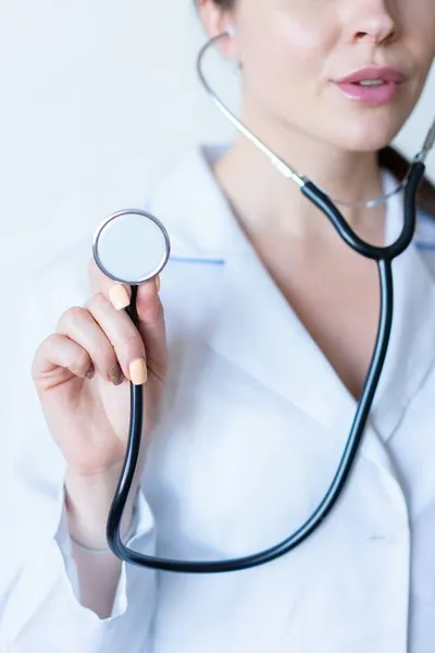 A female doctor holding a stethoscope