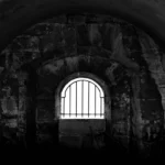 An old jail cell in black and white