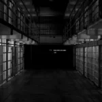 black and white shot of a row of jail cells