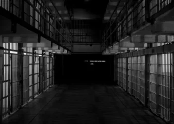 black and white shot of a row of jail cells
