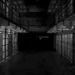 black and white shot of a row of jail cells