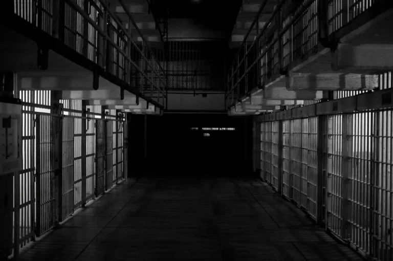 black and white shot of a row of jail cells