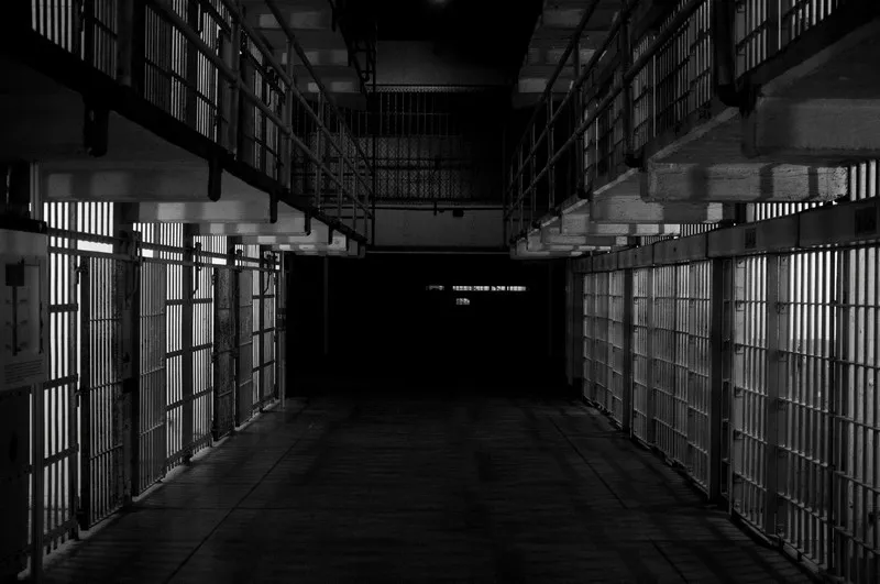 black and white shot of a row of jail cells