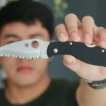 A man holding a knife to the camera