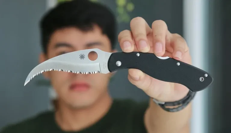 A man holding a knife to the camera