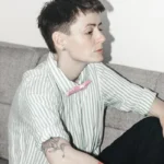 A non-binary person observing