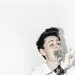 A ladette eating flowers against a white background