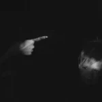 A blacked out image of a finger waving at a naughty child