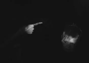 A blacked out image of a finger waving at a naughty child