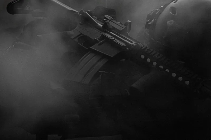 A fully automatic assault rifle in black and white with smoke