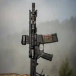 A fully automatic rifle standing upright on a tree stump
