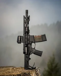 A fully automatic rifle standing upright on a tree stump