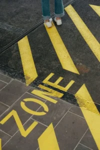 a floor marking in yellow stating 'zone'